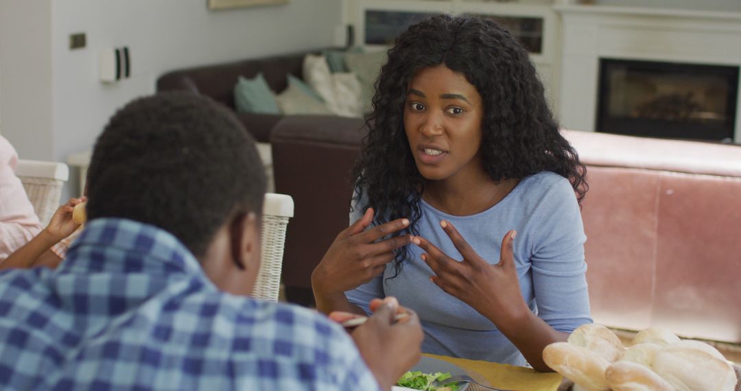 Concerned African American Woman Talking to Child During Meal at Home - Free Images, Stock Photos and Pictures on Pikwizard.com