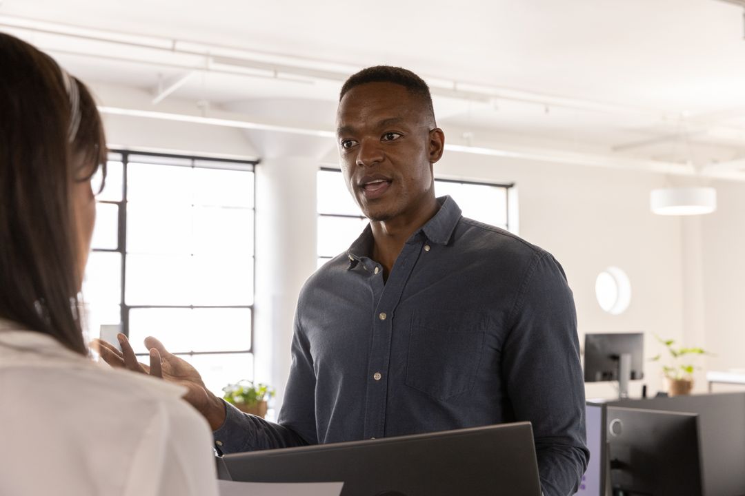 Coworkers Collaborating in Modern Open Office Setting