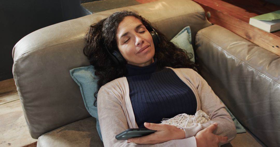 Peaceful Woman Relaxing on Couch with Headphones - Free Images, Stock Photos and Pictures on Pikwizard.com