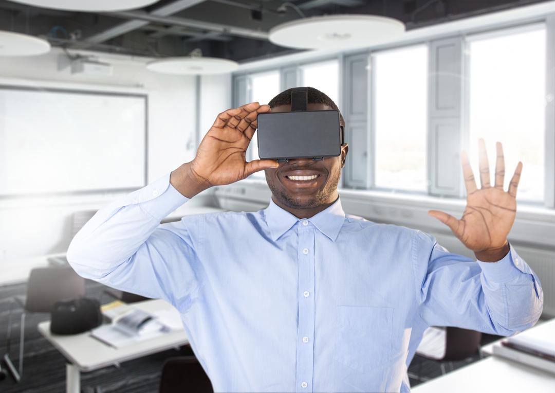 Smiling Man Using Virtual Reality Headset in Modern Office - Free Images, Stock Photos and Pictures on Pikwizard.com