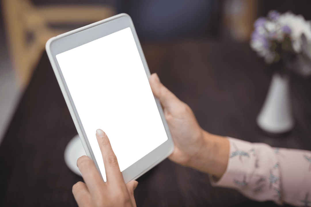 Female Hands Browsing Empty Transparent Tablet Screen in Restaurant