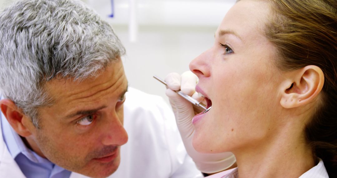 Dentist Examining Female Patient's Teeth During Dental Checkup - Free Images, Stock Photos and Pictures on Pikwizard.com