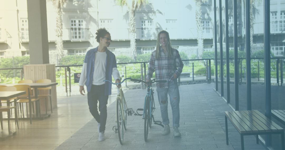 Two Friends Enjoying Day Out with Bicycles at Cafe