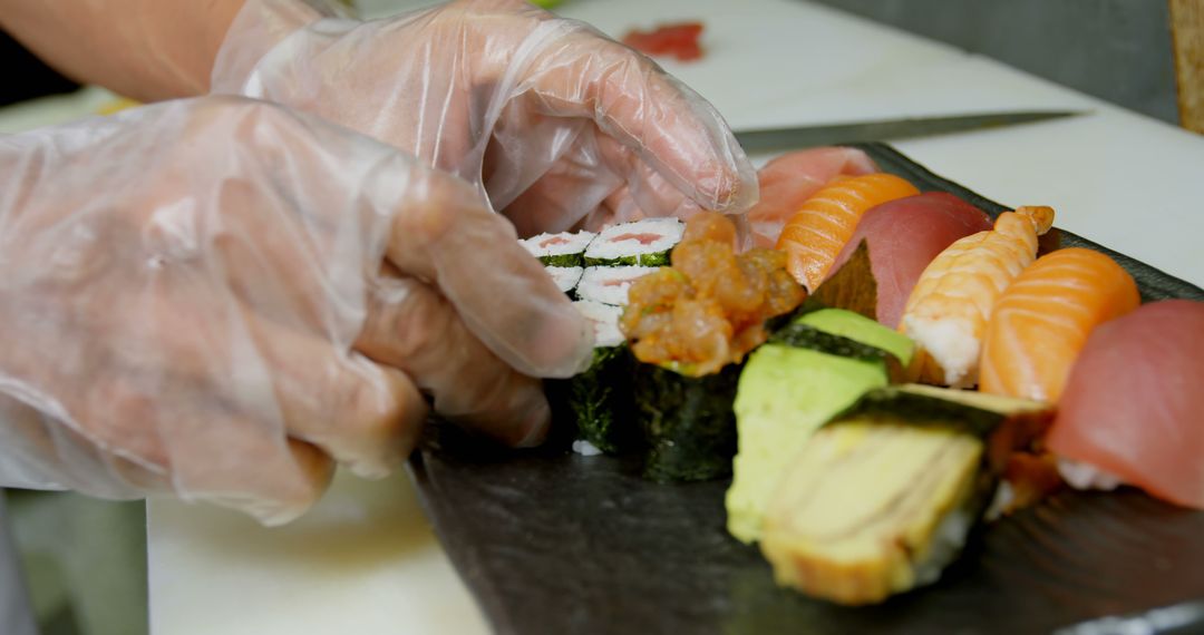 Close-Up of Chef's Hands Preparing Assorted Sushi Platter - Free Images, Stock Photos and Pictures on Pikwizard.com