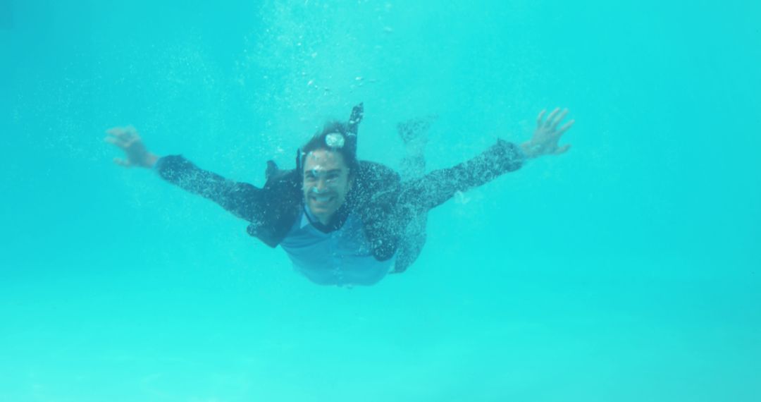 Man fully dressed underwater in swimming pool, feeling liberated - Free Images, Stock Photos and Pictures on Pikwizard.com