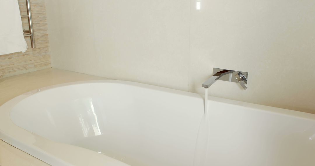 Modern White Bathtub with Flowing Water in Minimalist Bathroom - Free Images, Stock Photos and Pictures on Pikwizard.com