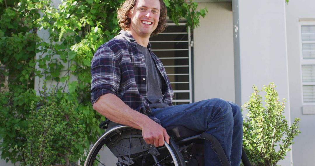 Smiling man in wheelchair outdoors near home - Free Images, Stock Photos and Pictures on Pikwizard.com