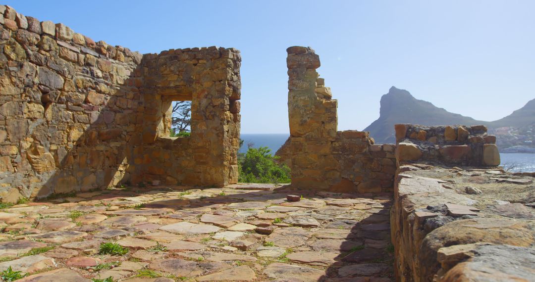 Ancient Stone Ruins Overlooking Ocean on Sunny Day - Free Images, Stock Photos and Pictures on Pikwizard.com