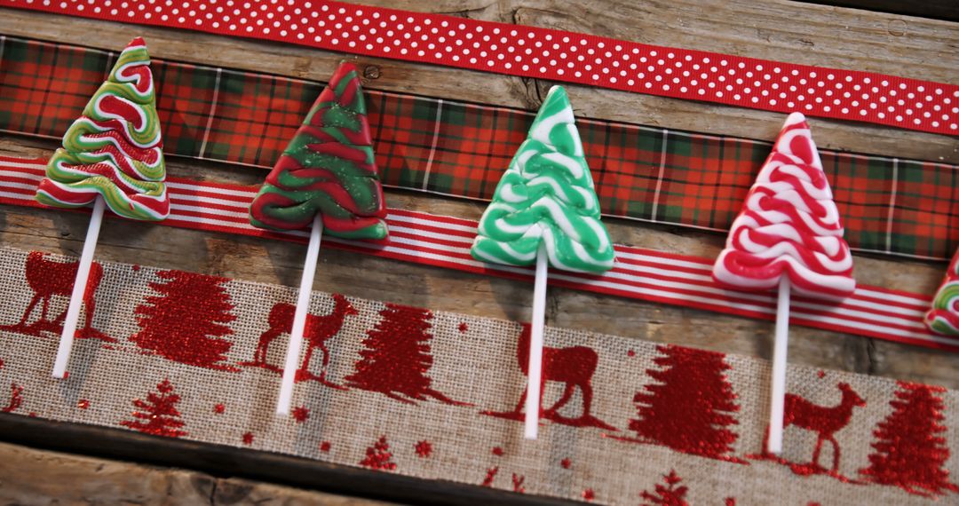 Festive Christmas Tree Lollipops on Rustic Wooden Background - Free Images, Stock Photos and Pictures on Pikwizard.com