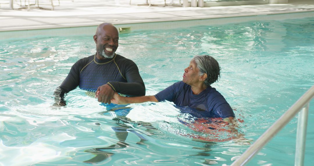 Image of happy african american couple swimming in the pool - Free Images, Stock Photos and Pictures on Pikwizard.com