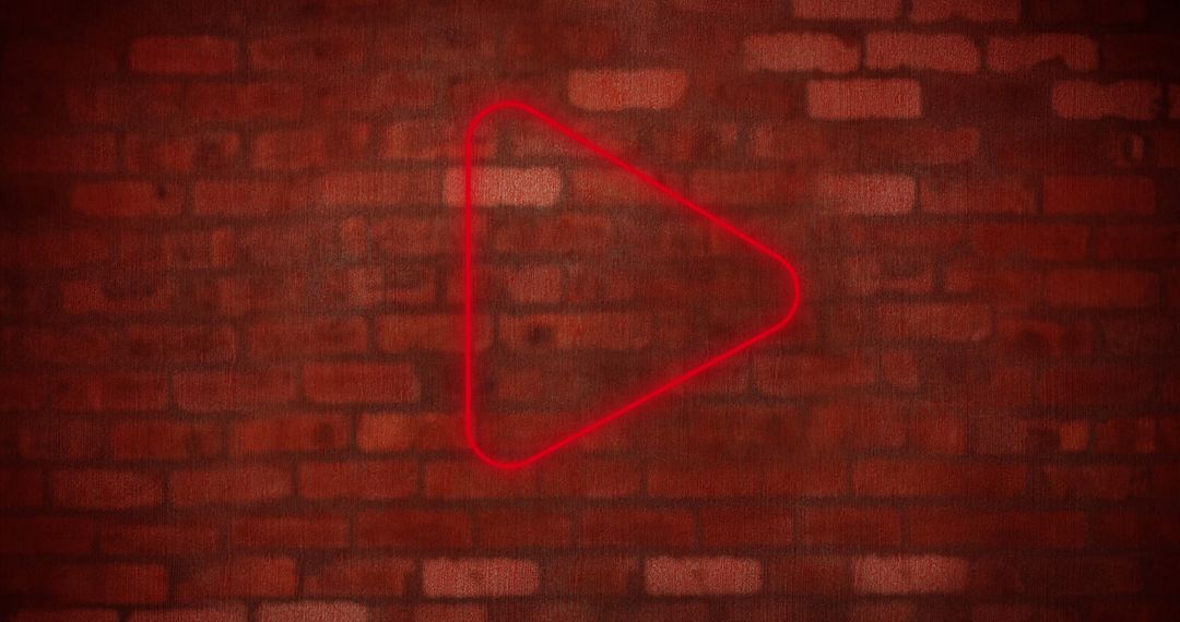 Glowing Red Play Icon on Brick Wall Background