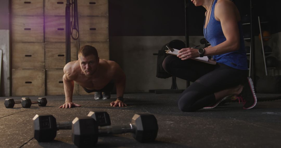 Cross Training with Personal Trainer Coaching Push-Ups in Gym