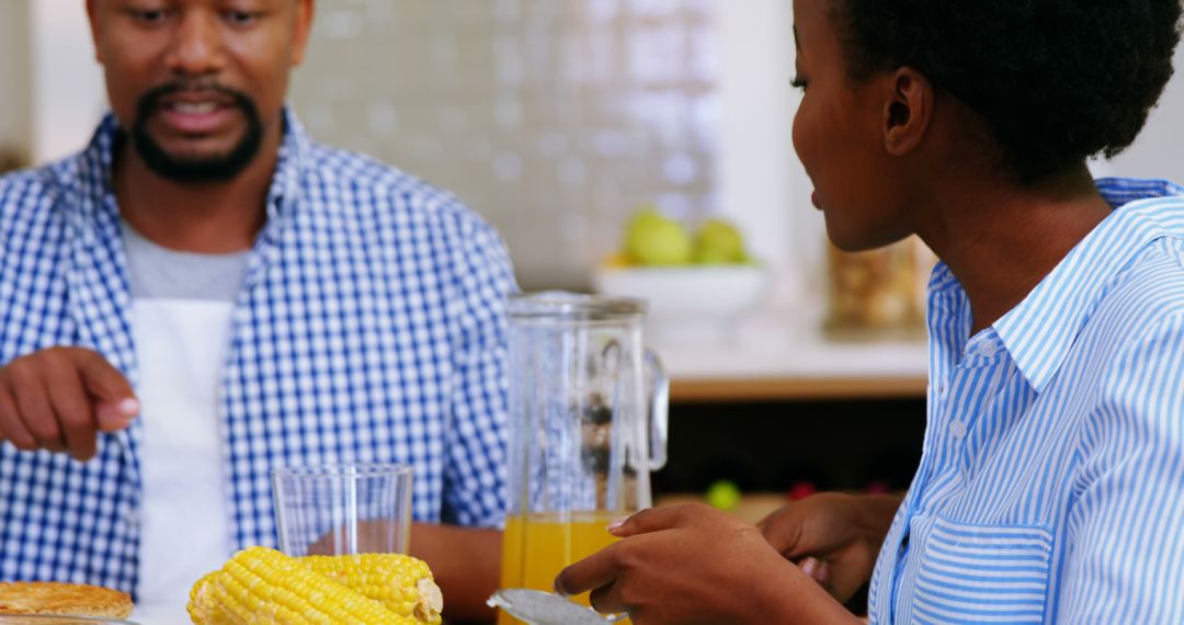 African American Couple Enjoying Breakfast with Corn and Orange Juice - Free Images, Stock Photos and Pictures on Pikwizard.com