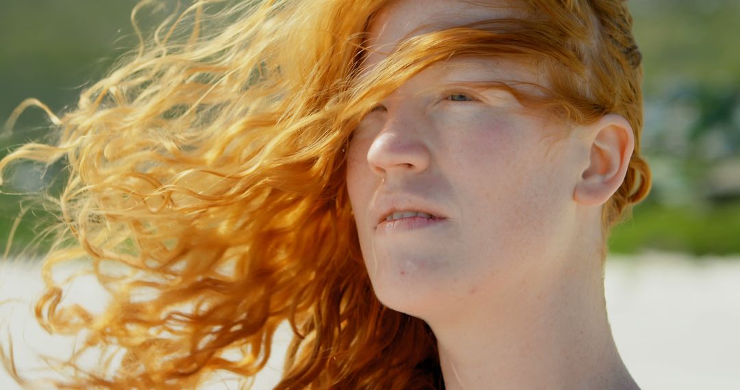 Red-haired Person Gazing at Distance on Sandy Beach - Free Images, Stock Photos and Pictures on Pikwizard.com