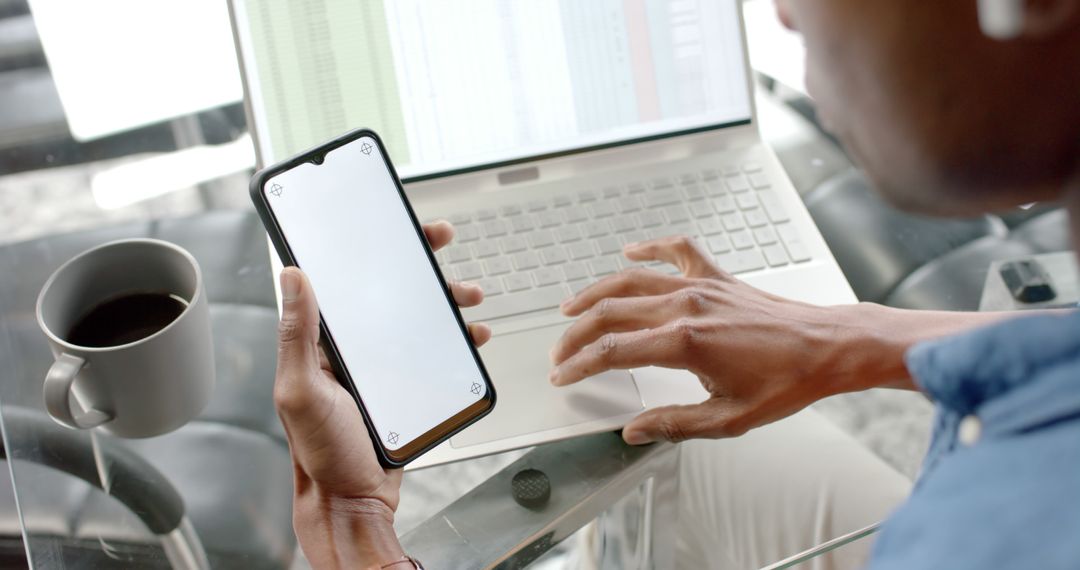 Person Working on Financial Spreadsheet with Smartphone and Laptop - Free Images, Stock Photos and Pictures on Pikwizard.com