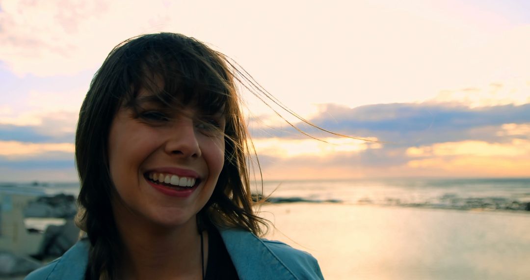 Smiling Woman Enjoying Sunset by the Beach - Free Images, Stock Photos and Pictures on Pikwizard.com