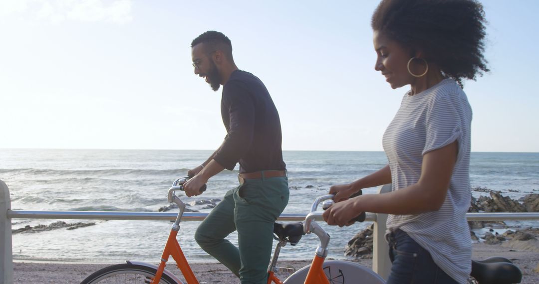 Couple Riding Bicycles Along Oceanfront at Sunset - Free Images, Stock Photos and Pictures on Pikwizard.com