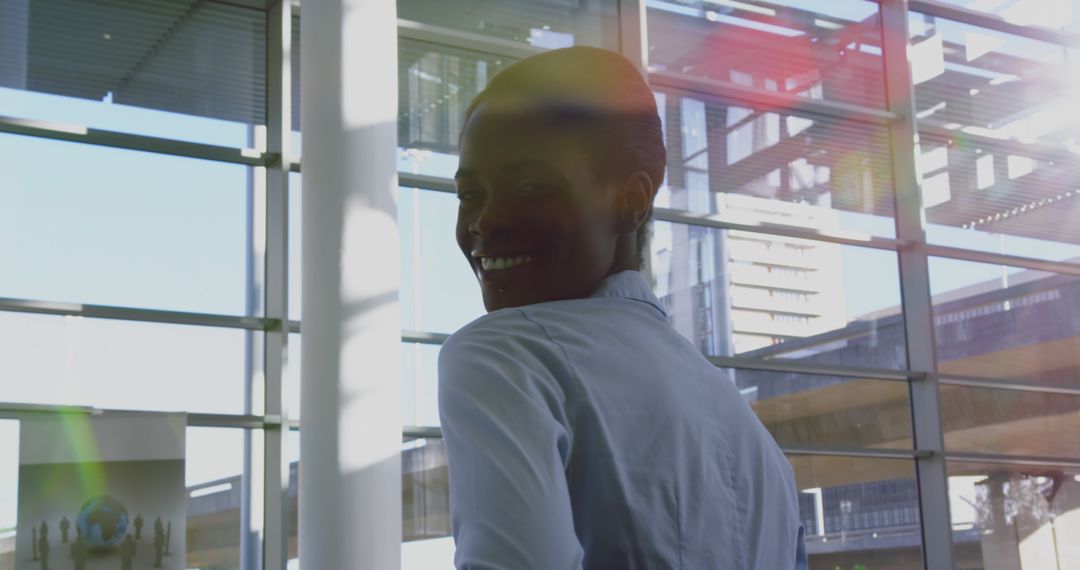 Smiling African American Businesswoman in Modern Office with City View - Free Images, Stock Photos and Pictures on Pikwizard.com