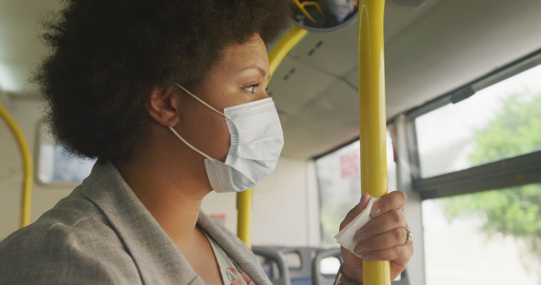 Biracial Woman in Face Mask Commuting on Bus During Pandemic