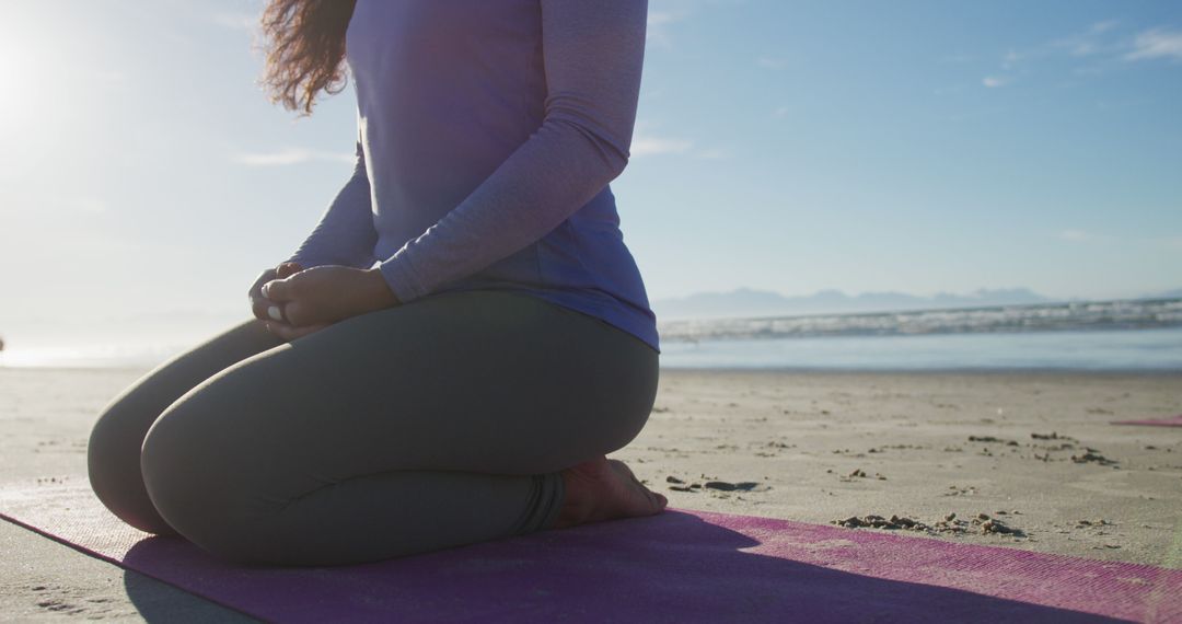 Woman Meditating on Beach During Sunrise - Free Images, Stock Photos and Pictures on Pikwizard.com