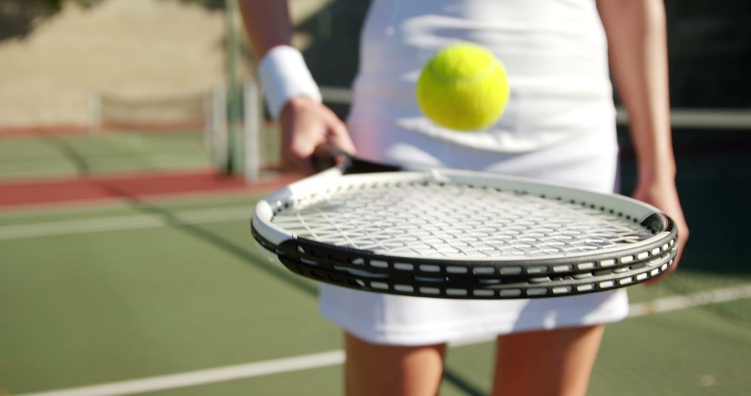 Female Tennis Player Bouncing Ball on Racket - Free Images, Stock Photos and Pictures on Pikwizard.com