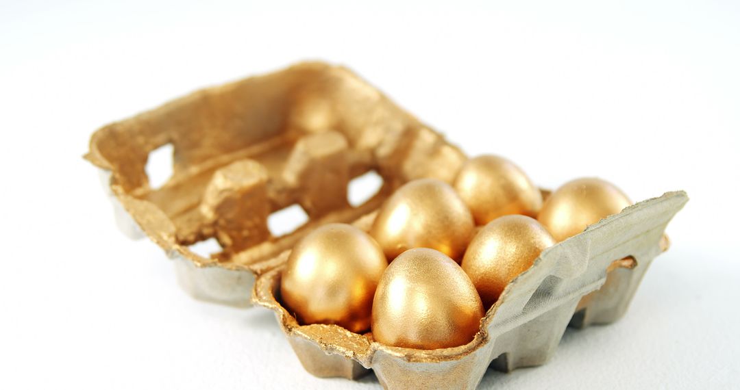 Golden Eggs in a Carton on White Background - Free Images, Stock Photos and Pictures on Pikwizard.com