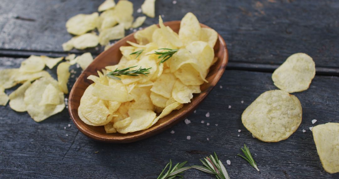 Freshly Made Potato Chips with Rosemary Garnish on Rustic Table - Free Images, Stock Photos and Pictures on Pikwizard.com
