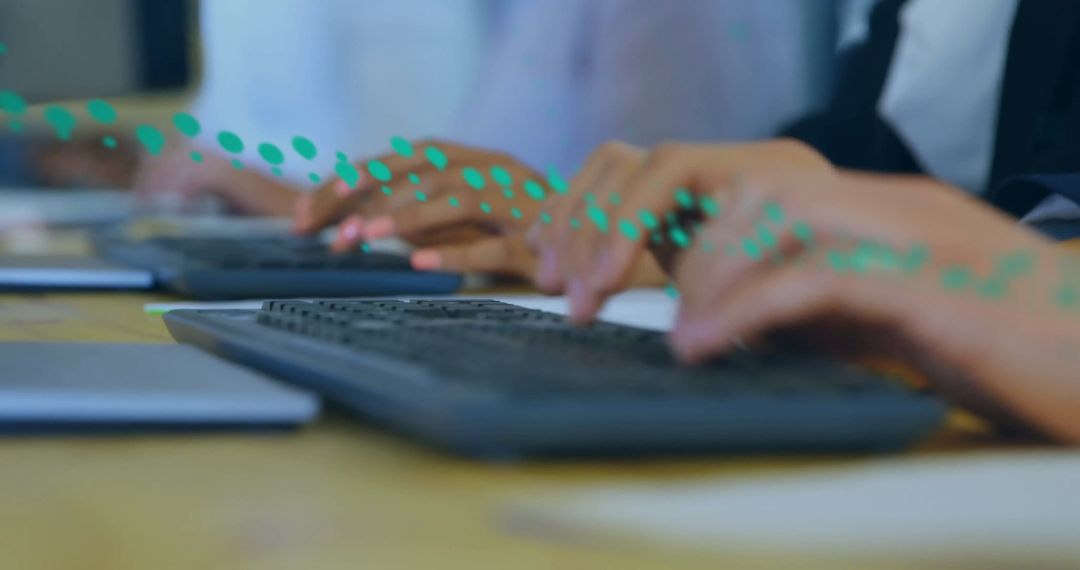 Hands Typing on Keyboards in Busy Office Setting
