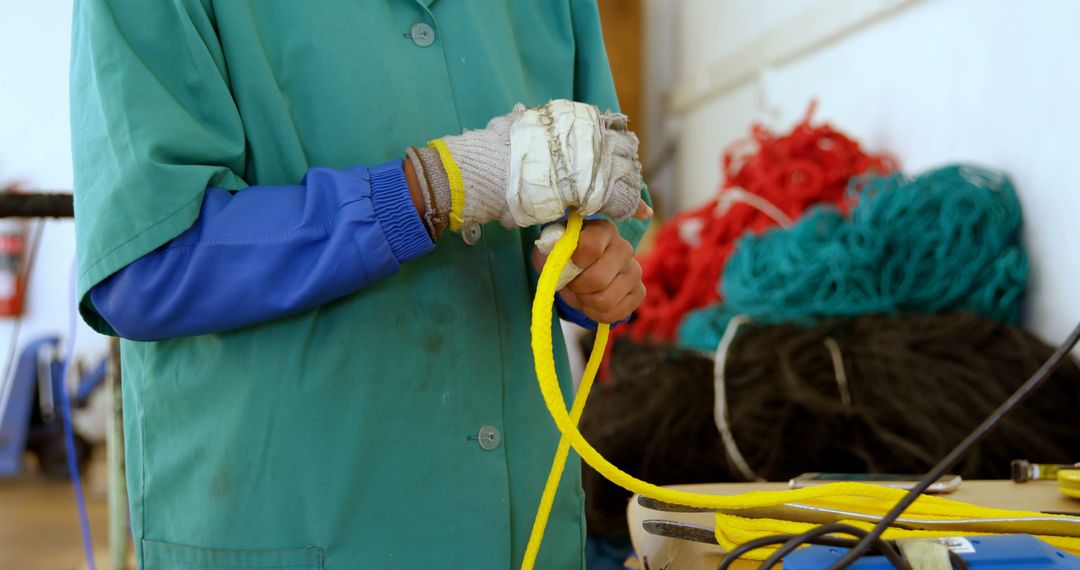 Fisherman Meticulously Braiding Bright Yellow Rope - Free Images, Stock Photos and Pictures on Pikwizard.com