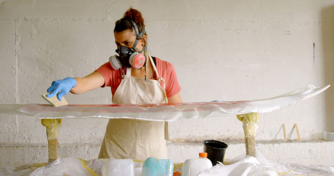 Woman Crafting Surfboard in Workshop with Safety Gear - Free Images, Stock Photos and Pictures on Pikwizard.com