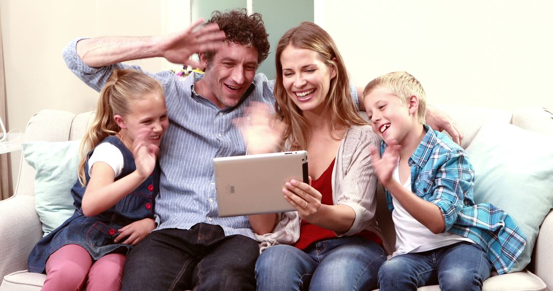 Happy Family Video Calling on Tablet Together in Living Room - Free Images, Stock Photos and Pictures on Pikwizard.com