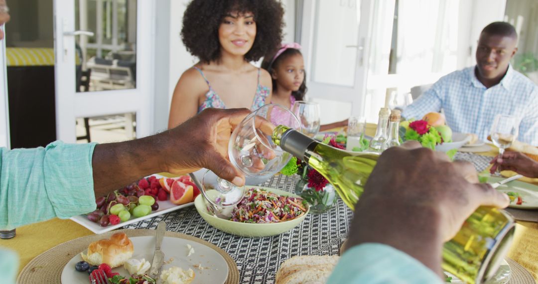 Image of african american family spending time together and having dinner outside - Free Images, Stock Photos and Pictures on Pikwizard.com