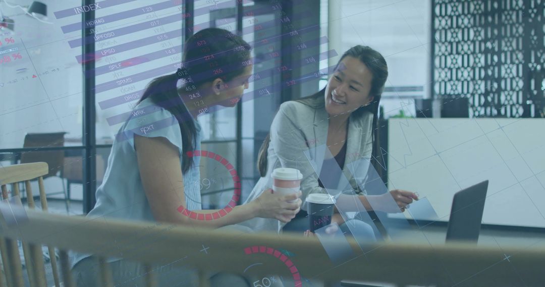 Businesswomen Analyzing Financial Projections in Modern Office