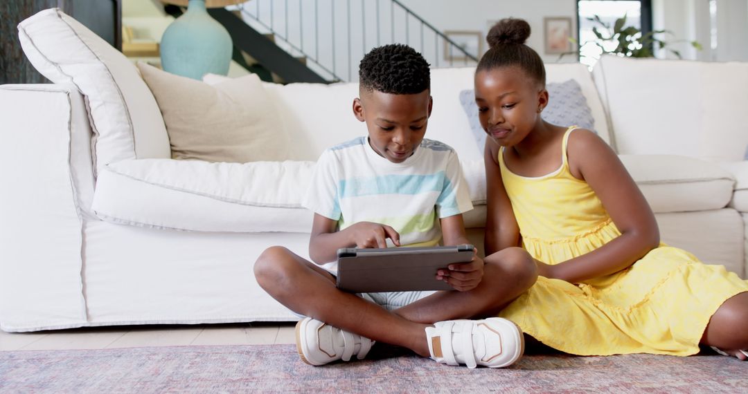 Children Engaging in Technology Together at Home with Tablet