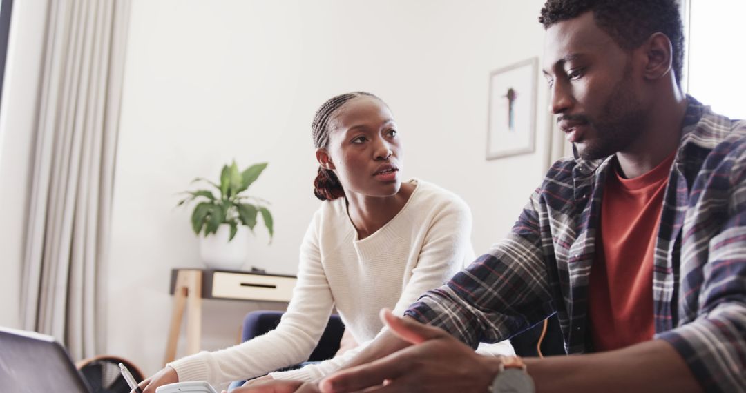 Couple Reviewing Finances Together in Living Room