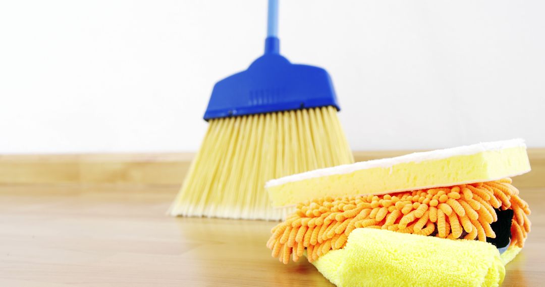 Cleaning Supplies on Wooden Floor with Broom in Background - Free Images, Stock Photos and Pictures on Pikwizard.com