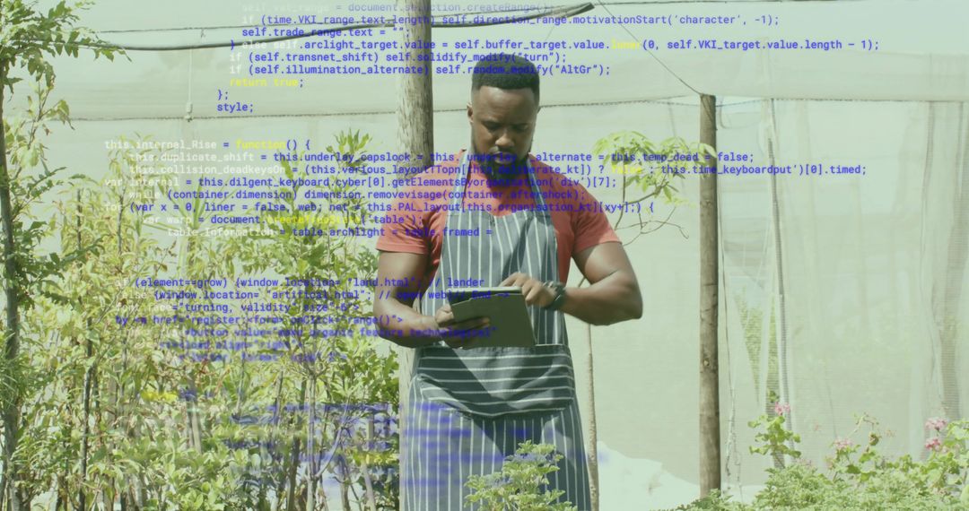 Greenhouse worker tapping tablet while monitoring plant growth for sustainable farming