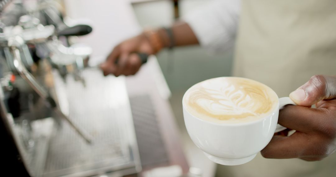 Barista Holding Fresh Cappuccino with Beautiful Latte Art
