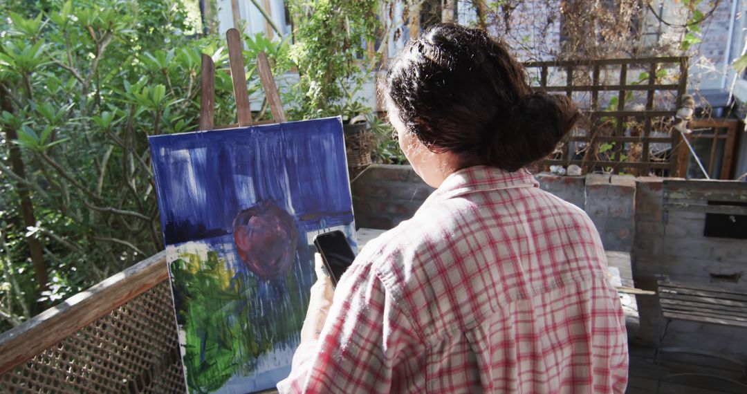 Woman Painting Outdoors on a Sunny Day - Free Images, Stock Photos and Pictures on Pikwizard.com