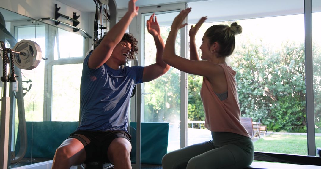 Young Couple Exercising with Dumbbells in a Gym Setting