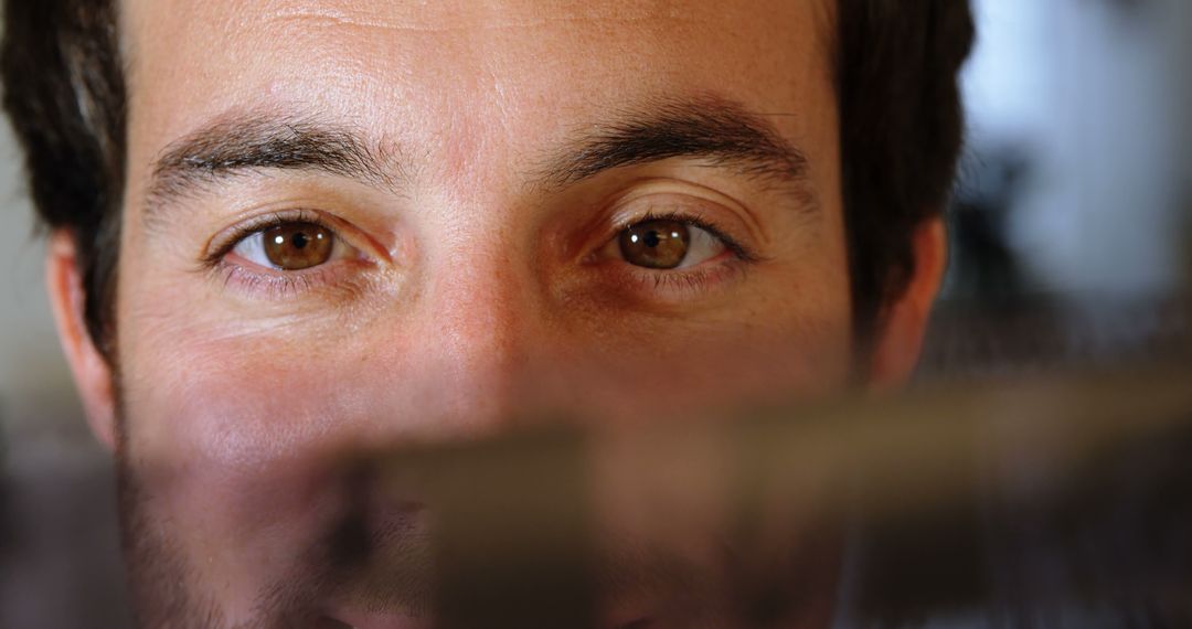 Close-Up of Man with Brown Eyes in Soft Lighting - Free Images, Stock Photos and Pictures on Pikwizard.com