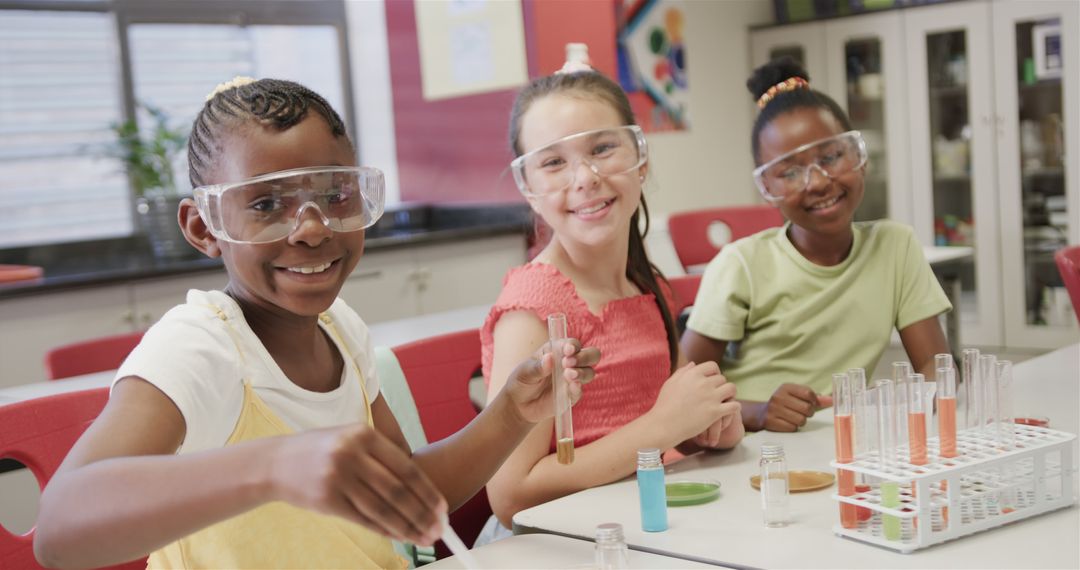 Girls Conducting Science Experiment in Classroom with Test Tubes and Safety Goggles - Free Images, Stock Photos and Pictures on Pikwizard.com