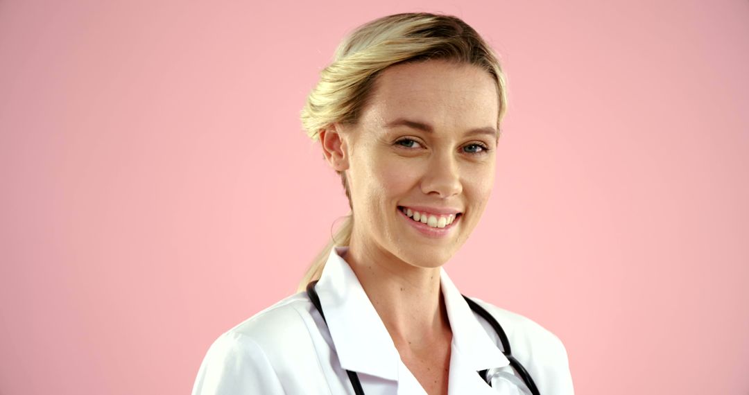 Smiling Female Doctor with Stethoscope on Pink Background - Free Images, Stock Photos and Pictures on Pikwizard.com