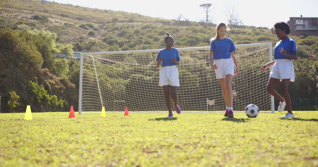 Girls Playing Soccer on School Field During Practice