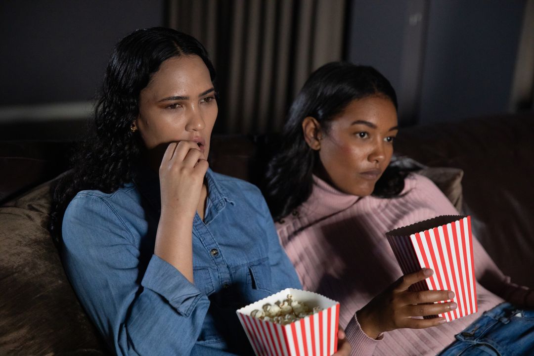 Diverse Friends Relaxing on Couch with Popcorn