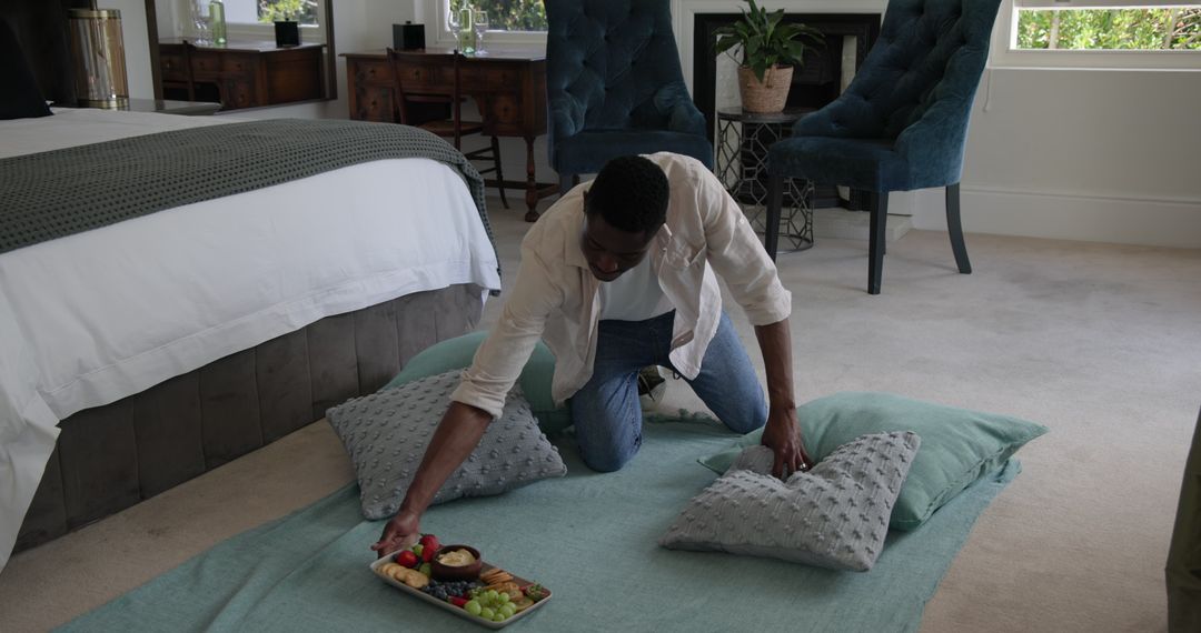Man Arranging Breakfast in Luxurious Bedroom