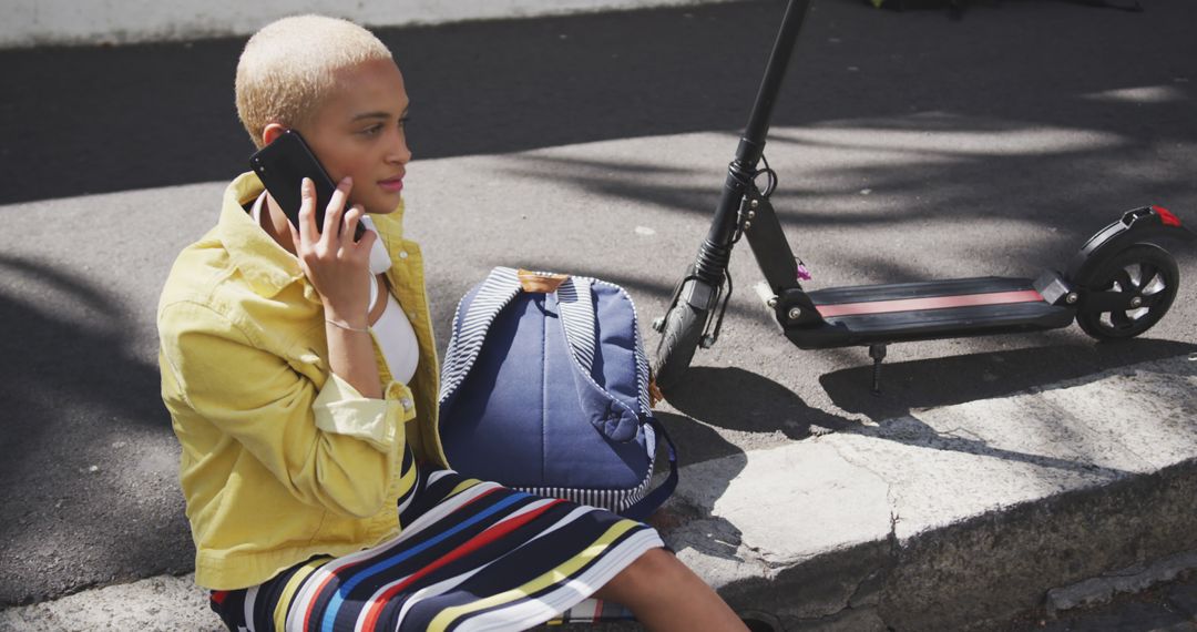 Woman Using Smartphone in Urban Environment with Scooter