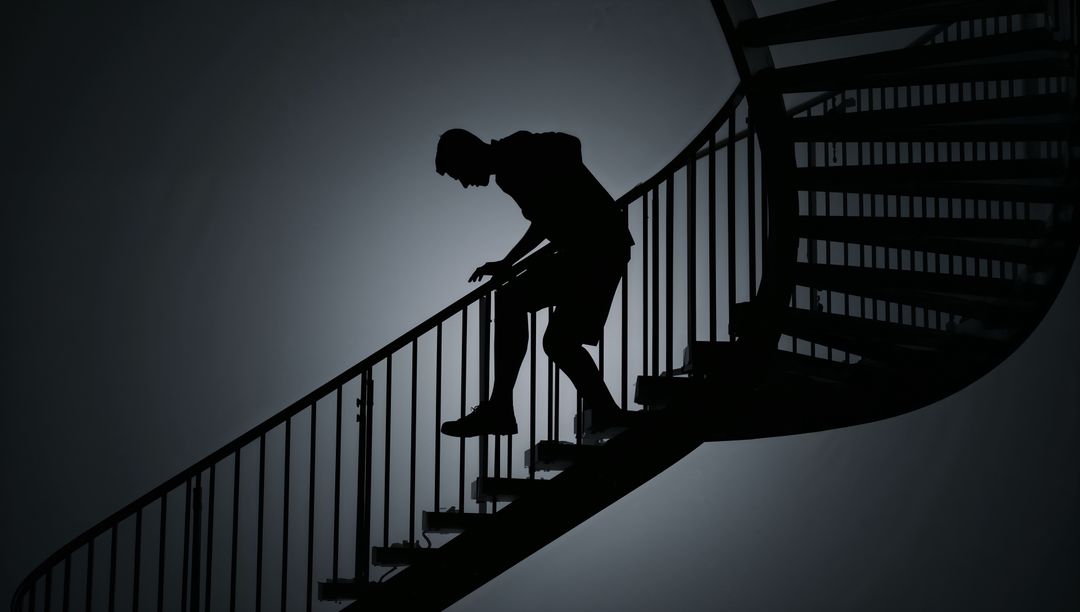 Silhouetted Man Climbing Curved Spiral Staircase Holding Railing Backlit Minimalist Ascent