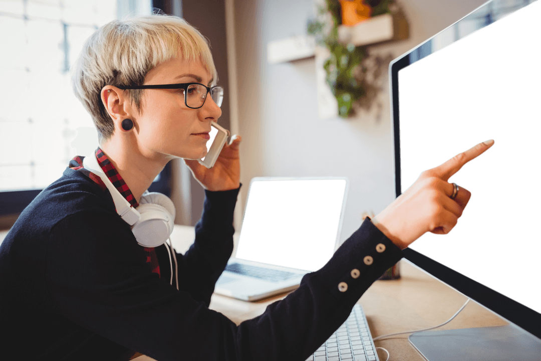 Confident Businesswoman on Phone Pointing at Transparent Computer Screen