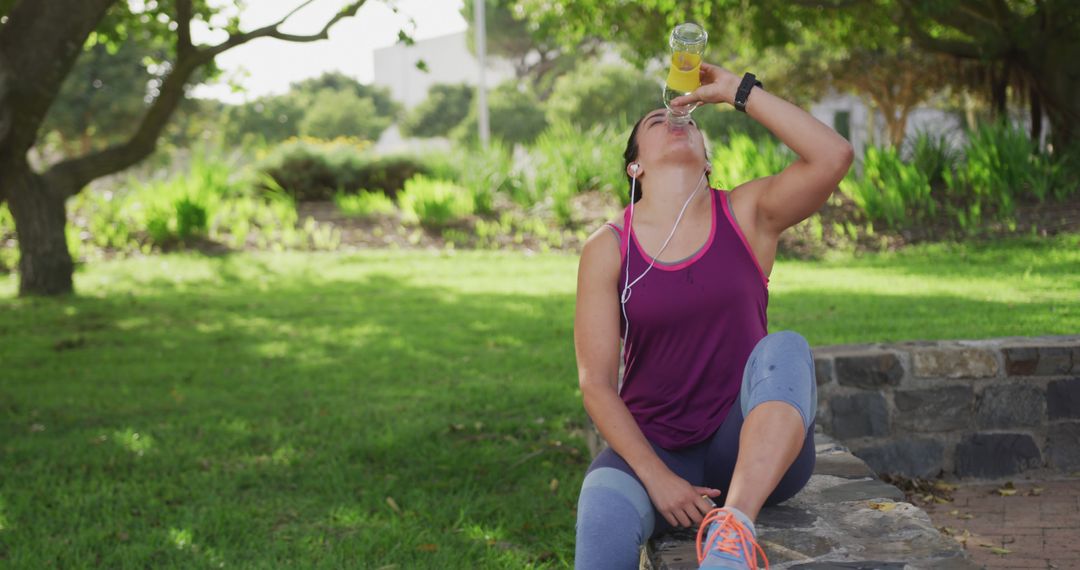 Woman Drinking Juice While Exercising Outdoors in Park - Free Images, Stock Photos and Pictures on Pikwizard.com